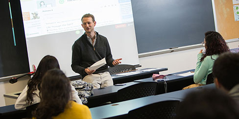 Professor giving a class about Behavioral Studies