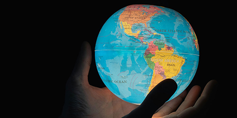 World View, someone holding a world globe