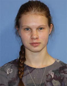 Eirena Saylor with a long braided ponytail against a blue background, representing academic support at Houston Christian Univ.