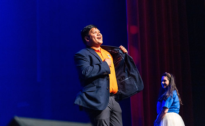 Student performing on stage at Dunham Theater during a Homecoming 2026 theater rehearsal.