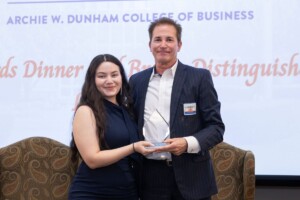 Student receiving an award at the Dunham Theater business dinner.
