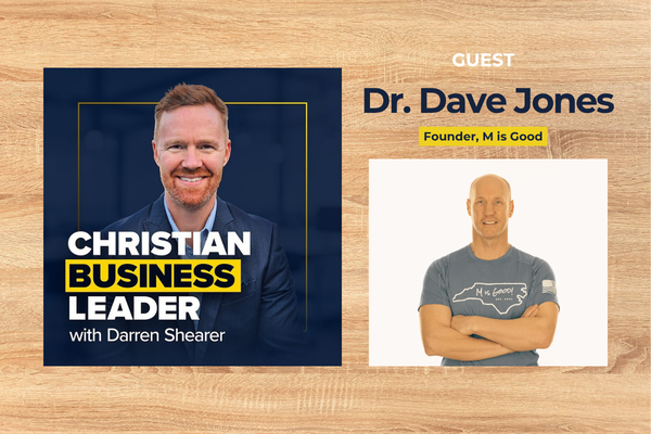 Dr. Dave Jones smiles in a gray M is Good shirt, guest on Christian Business Leader podcast at HCU campus.