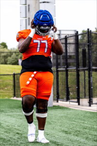 Kendal Septs puts on a helmet at practice