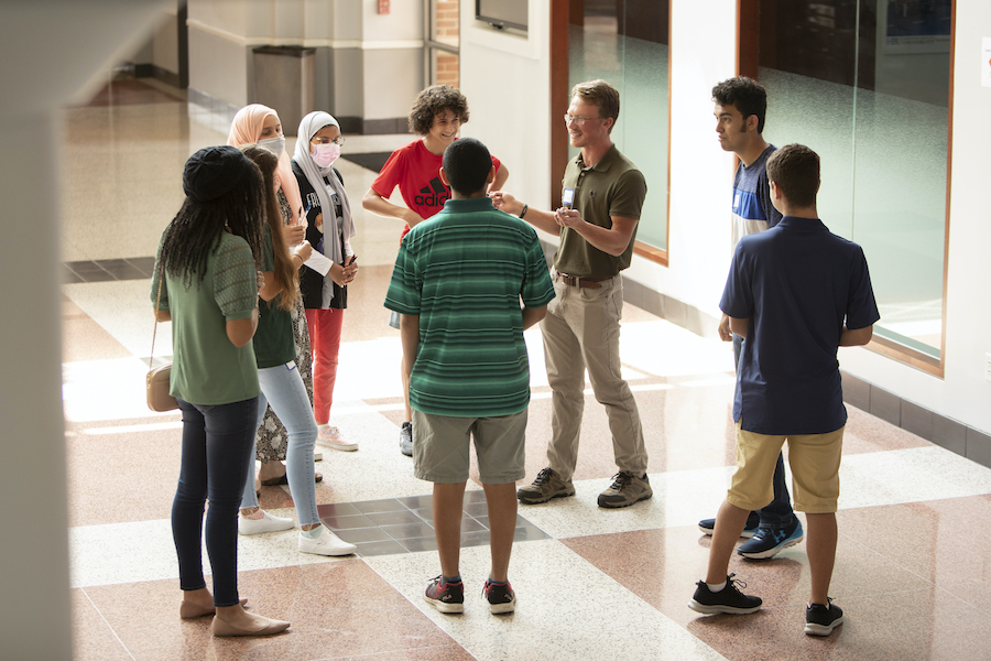 returning, and prospective Academy students talking to each other