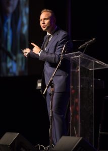 Dr. Jeremiah Johnston speaking onstage