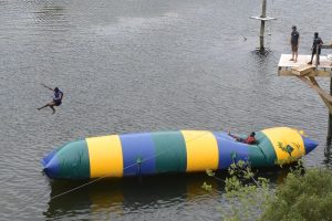 Students jumping into a lake