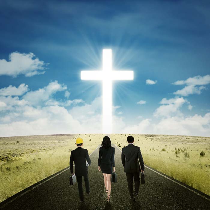 Business team walking toward a cross